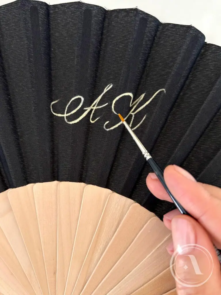 Fächer aus Birnbaumholz, bemalt von der Künstlerin Anna Kazennova mit Monogramm in goldener Kalligrafie, schwarzer Parfüm-Fächer.